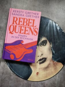 Rebel Queens. Das Buch der Grether Schwestern liegt auf der legendären Picture Disc der Nina Hagen Band